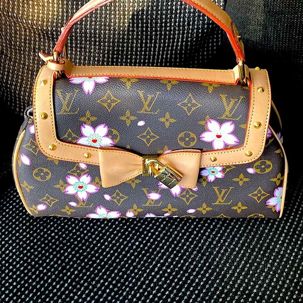 LV vintage bag with gold embellishments.  Knockoff.